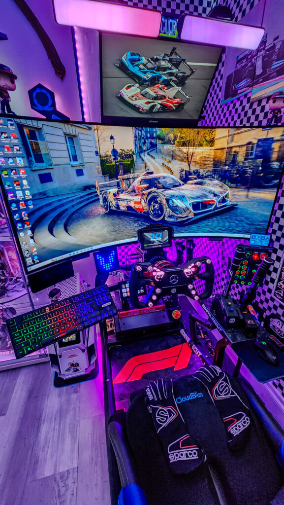 High-tech racing game console featuring dual screens, multiple joysticks, F1-style gaming chair with vibration, neon lights, and racing-themed carpet